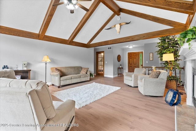 4582 N Watson Rd, Elsie, MI 48831 - living area with light wood-style flooring, beamed ceiling, baseboards, ceiling fan, and high vaulted ceiling