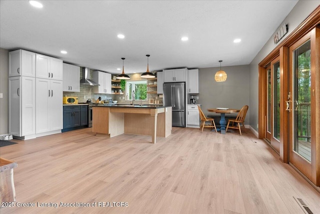 4582 N Watson Rd, Elsie, MI 48831 - kitchen featuring wall chimney exhaust hood, appliances with stainless steel finishes, open shelves, plenty of natural light, and recessed lighting