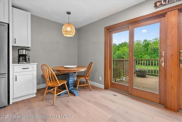 4582 N Watson Rd, Elsie, MI 48831 - dining room featuring light wood-style flooring and baseboards