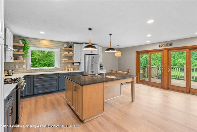 4582 N Watson Rd, Elsie, MI 48831 - kitchen featuring open shelves, stainless steel appliances, healthy amount of natural light, light wood-style flooring, and recessed lighting
