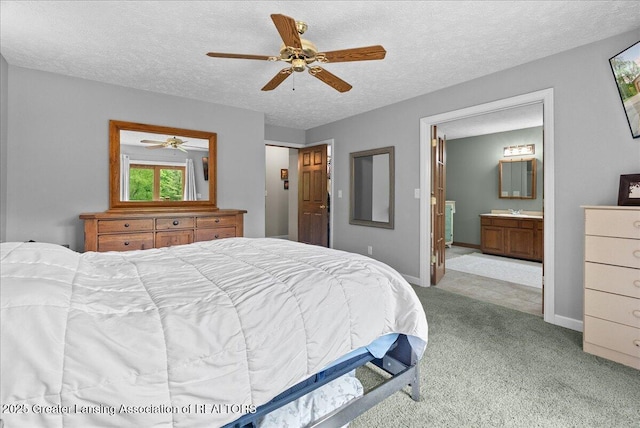 4582 N Watson Rd, Elsie, MI 48831 - carpeted bedroom featuring a textured ceiling, ensuite bath, baseboards, a sink, and a ceiling fan