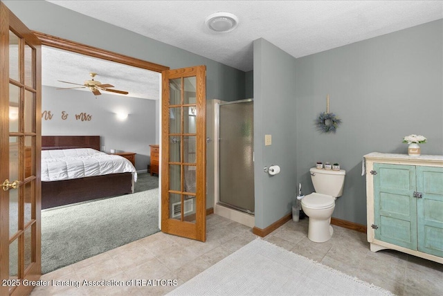 4582 N Watson Rd, Elsie, MI 48831 - bathroom with french doors, ensuite bathroom, a stall shower, a textured ceiling, and toilet