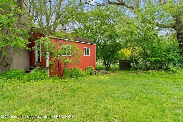 4582 N Watson Rd, Elsie, MI 48831 - view of green lawn featuring an outbuilding