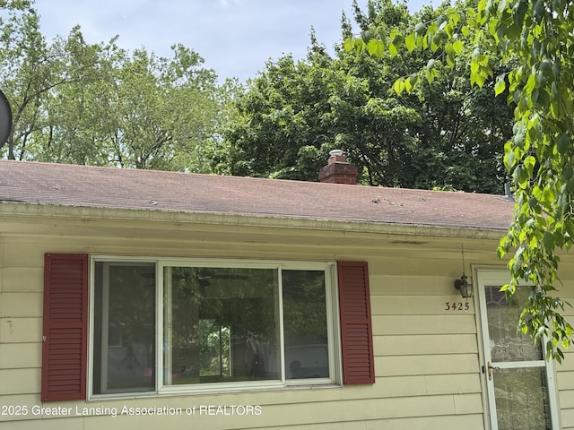3425 Cooley Dr, Lansing, MI 48911 - exterior view of roof with shingles and a chimney