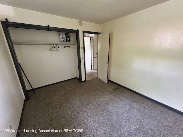 3425 Cooley Dr, Lansing, MI 48911 - unfurnished bedroom with carpet flooring, a closet, and baseboards
