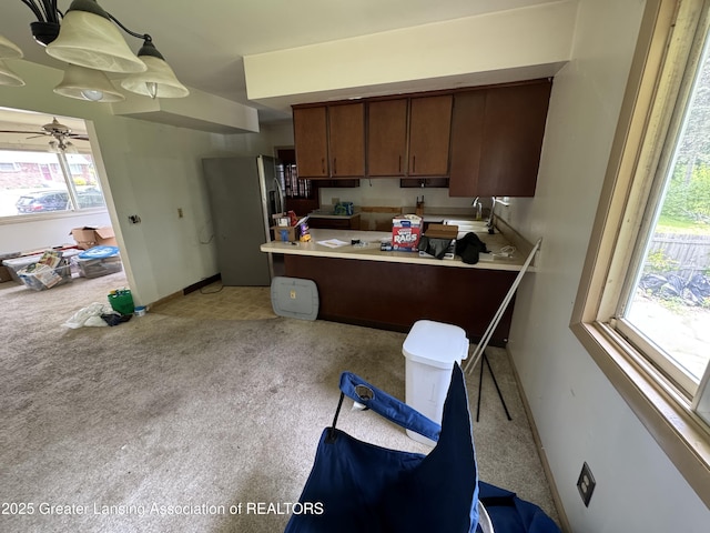 3425 Cooley Dr, Lansing, MI 48911 - kitchen with stainless steel refrigerator with ice dispenser, a ceiling fan, light carpet, and baseboards