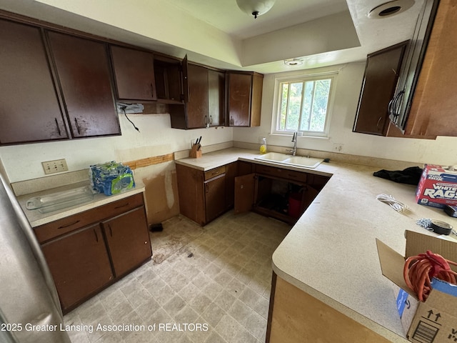 3425 Cooley Dr, Lansing, MI 48911 - kitchen featuring a sink, dark brown cabinets, light countertops, and light floors