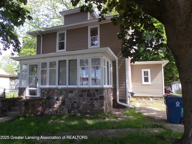210 E Capital Ave, Bellevue, MI 49021 - view of front facade with a sunroom