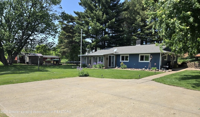 3066 S Canfield Rd, Eaton Rapids, MI 48827 - single story home with a front yard and a chimney