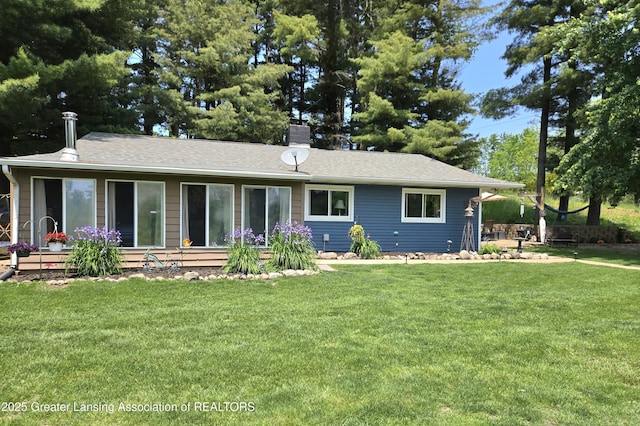 3066 S Canfield Rd, Eaton Rapids, MI 48827 - view of front of house with a chimney and a front lawn