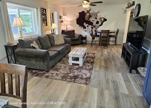 3066 S Canfield Rd, Eaton Rapids, MI 48827 - living area with wood finished floors and a ceiling fan