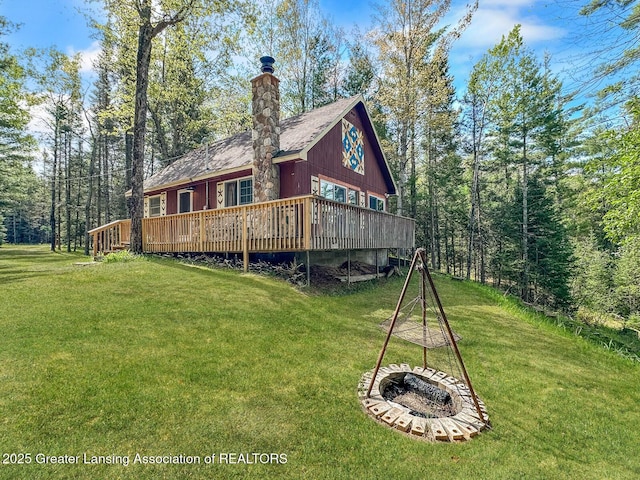 2623 Timberlane Trl, Grayling, MI 49738 - rear view of house with a yard, a deck, and a chimney