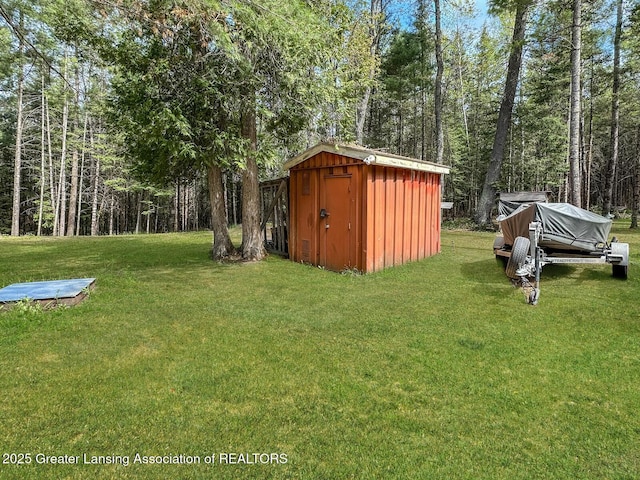 2623 Timberlane Trl, Grayling, MI 49738 - view of green lawn with a forest view