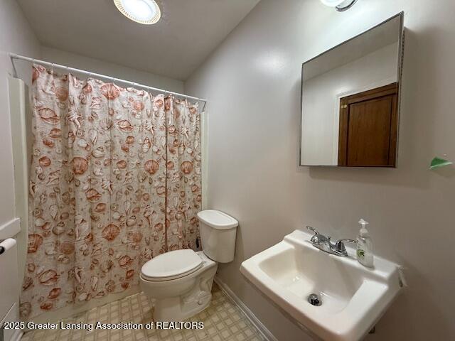 207 Wight St Unit 209, Elsie, MI 48831 - full bath featuring a sink, toilet, tile patterned floors, and a shower with shower curtain