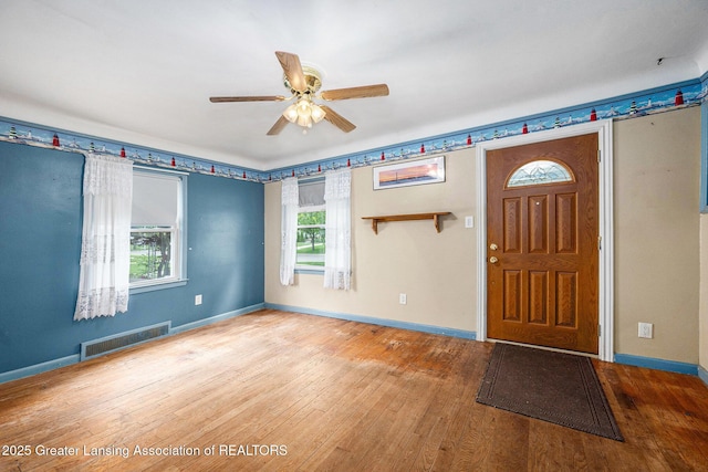 18762 Woodland St, Harper Woods, MI 48225 - foyer entrance featuring healthy amount of natural light, ceiling fan, hardwood / wood-style flooring, and baseboards