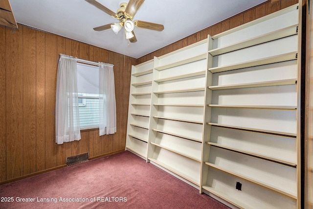 18762 Woodland St, Harper Woods, MI 48225 - carpeted spare room with wood walls and a ceiling fan