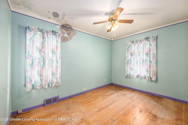 18762 Woodland St, Harper Woods, MI 48225 - spare room with a ceiling fan, hardwood / wood-style flooring, and baseboards