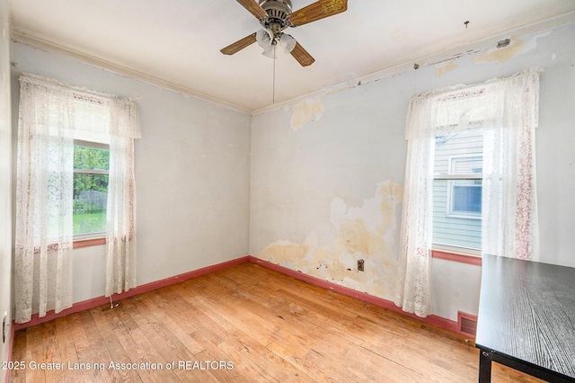 18762 Woodland St, Harper Woods, MI 48225 - empty room featuring hardwood / wood-style flooring, ceiling fan, ornamental molding, and baseboards