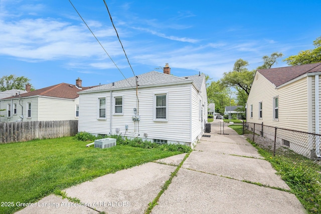 18762 Woodland St, Harper Woods, MI 48225 - back of property with a chimney, roof with shingles, and central air condition unit