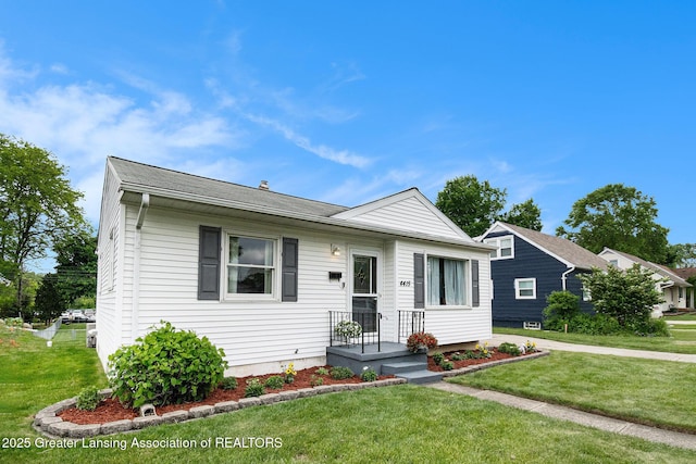 4415 Devonshire Ave, Lansing, MI 48910 - bungalow-style home with a front lawn and a shingled roof