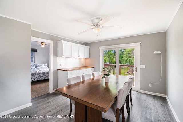 4415 Devonshire Ave, Lansing, MI 48910 - dining space featuring ceiling fan, wood finished floors, crown molding, and baseboards