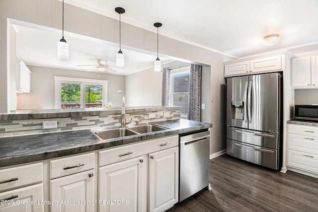 4415 Devonshire Ave, Lansing, MI 48910 - kitchen featuring stainless steel appliances, a sink, dark countertops, decorative backsplash, and ceiling fan