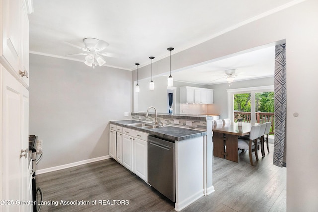 4415 Devonshire Ave, Lansing, MI 48910 - kitchen with ceiling fan, a sink, stainless steel dishwasher, a peninsula, and white cabinetry