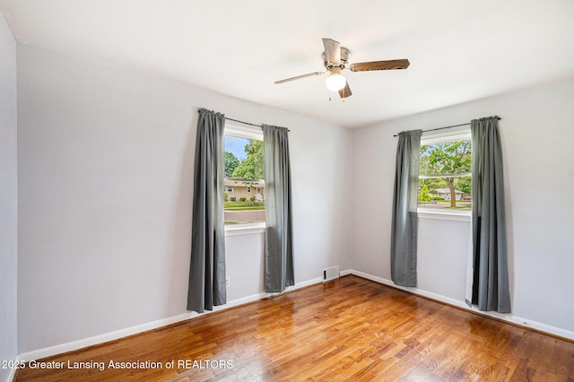 4415 Devonshire Ave, Lansing, MI 48910 - unfurnished room with plenty of natural light, light wood-style floors, baseboards, and a ceiling fan