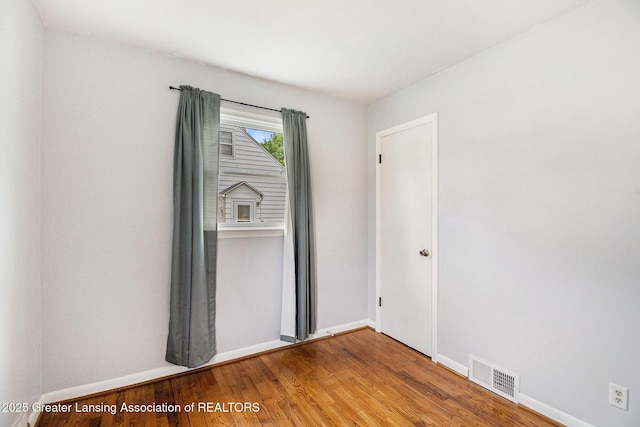 4415 Devonshire Ave, Lansing, MI 48910 - empty room with wood finished floors and baseboards