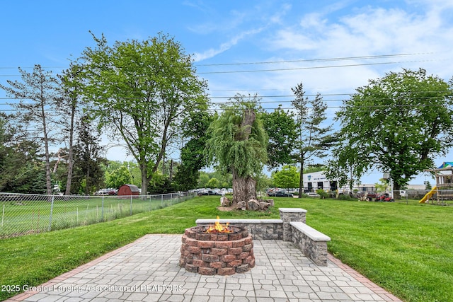 4415 Devonshire Ave, Lansing, MI 48910 - view of patio / terrace with an outdoor fire pit and a playground
