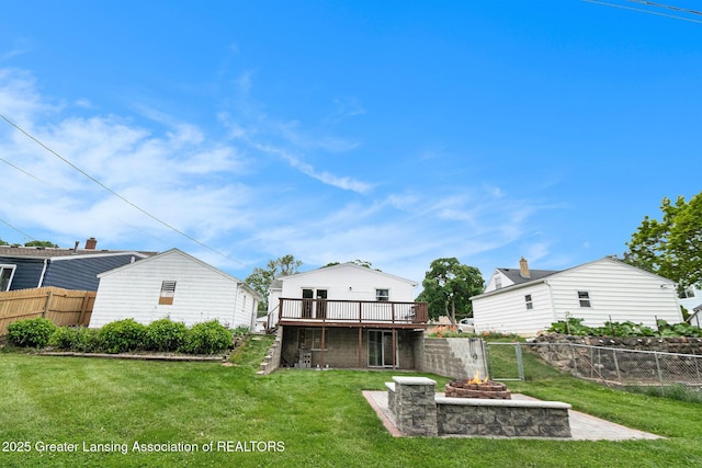 4415 Devonshire Ave, Lansing, MI 48910 - back of property featuring an outdoor fire pit and a wooden deck