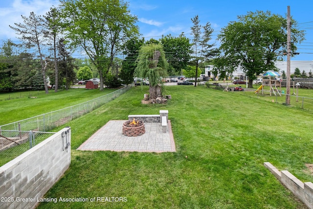 4415 Devonshire Ave, Lansing, MI 48910 - view of yard with a fire pit, a patio, and a playground