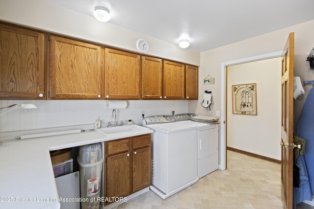 11781 W Herbison Rd, Eagle, MI 48822 - washroom featuring cabinet space, washer and clothes dryer, and baseboards