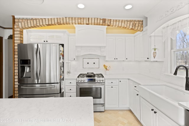 11781 W Herbison Rd, Eagle, MI 48822 - kitchen featuring stainless steel appliances, a sink, white cabinets, backsplash, and recessed lighting