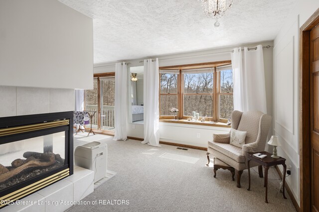 11781 W Herbison Rd, Eagle, MI 48822 - living area featuring healthy amount of natural light, a textured ceiling, carpet flooring, baseboards, and a tile fireplace