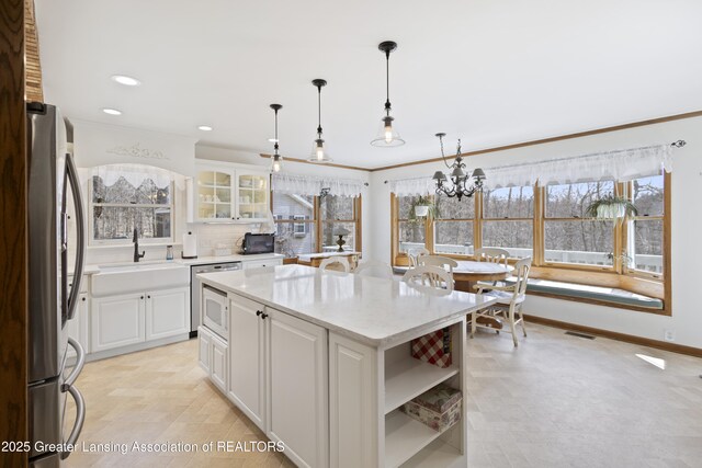 11781 W Herbison Rd, Eagle, MI 48822 - kitchen with freestanding refrigerator, a sink, open shelves, white cabinetry, and recessed lighting