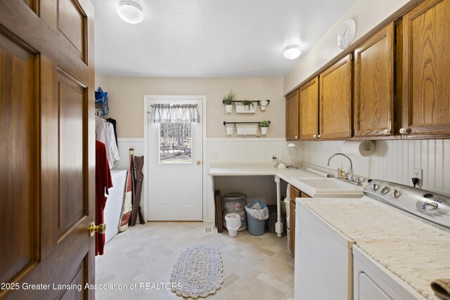 11781 W Herbison Rd, Eagle, MI 48822 - laundry room featuring cabinet space, a wainscoted wall, and washing machine and dryer