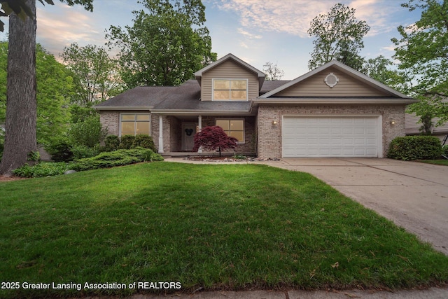1058 Buckingham Rd, Haslett, MI 48840 - view of front of property with brick siding, a garage, concrete driveway, and a front yard