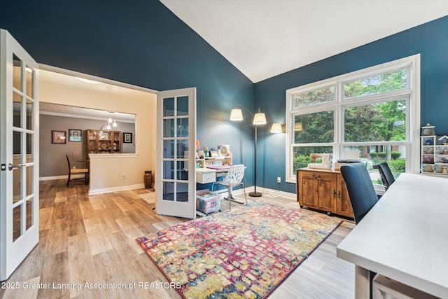 1058 Buckingham Rd, Haslett, MI 48840 - home office featuring french doors, wood finished floors, lofted ceiling, baseboards, and a chandelier