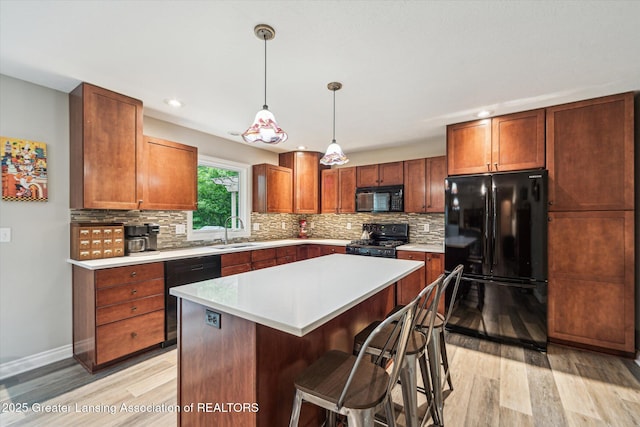 1058 Buckingham Rd, Haslett, MI 48840 - kitchen with black appliances, light wood-style floors, backsplash, light countertops, and recessed lighting