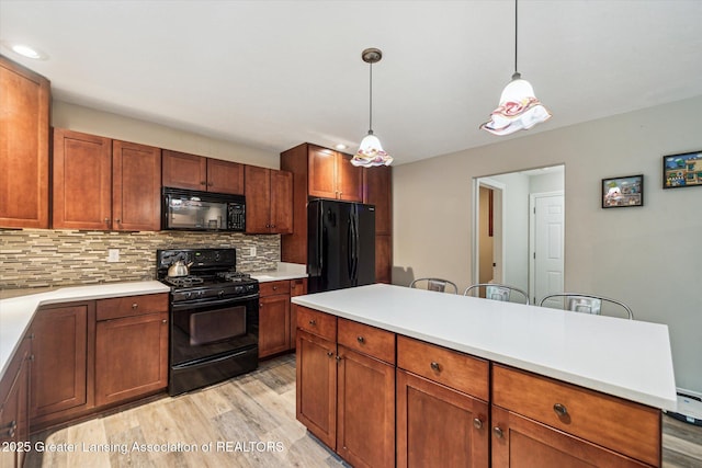 1058 Buckingham Rd, Haslett, MI 48840 - kitchen with black appliances, light wood-style flooring, backsplash, recessed lighting, and light countertops