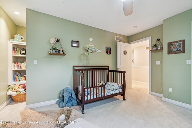 1058 Buckingham Rd, Haslett, MI 48840 - carpeted bedroom featuring baseboards and a crib