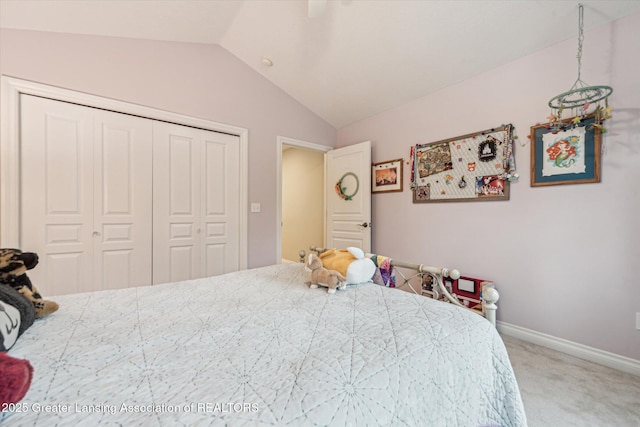 1058 Buckingham Rd, Haslett, MI 48840 - bedroom with vaulted ceiling, a closet, light colored carpet, baseboards, and ceiling fan