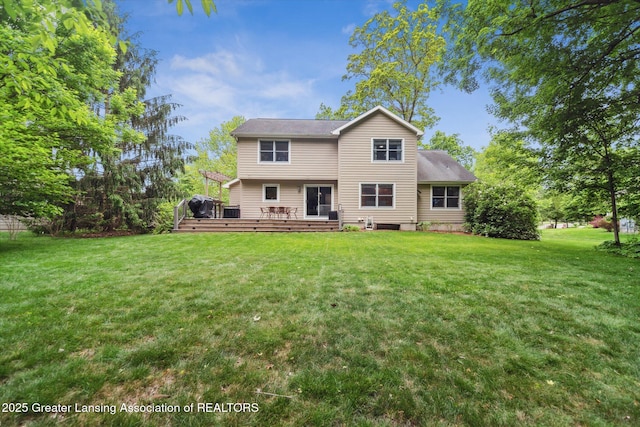 1058 Buckingham Rd, Haslett, MI 48840 - rear view of house with a wooden deck and a lawn