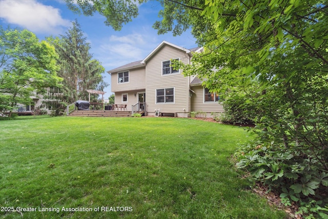 1058 Buckingham Rd, Haslett, MI 48840 - back of house with a deck and a lawn