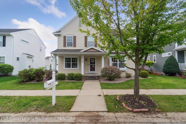 2705 Tapestry Dr Unit 53, Okemos, MI 48864 - traditional-style house featuring a front lawn and covered porch