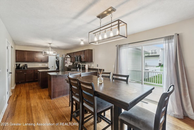 2705 Tapestry Dr Unit 53, Okemos, MI 48864 - dining area featuring wood finished floors and a textured ceiling