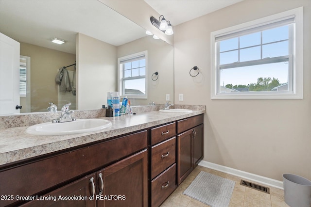 2705 Tapestry Dr Unit 53, Okemos, MI 48864 - bathroom with double vanity, baseboards, tile patterned floors, and a shower