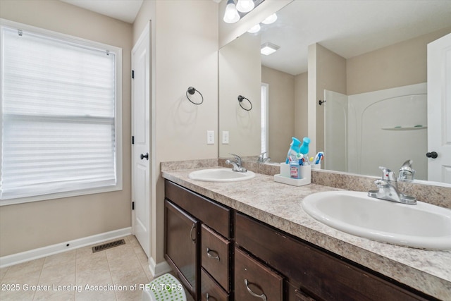 2705 Tapestry Dr Unit 53, Okemos, MI 48864 - bathroom featuring double vanity, baseboards, and tile patterned flooring
