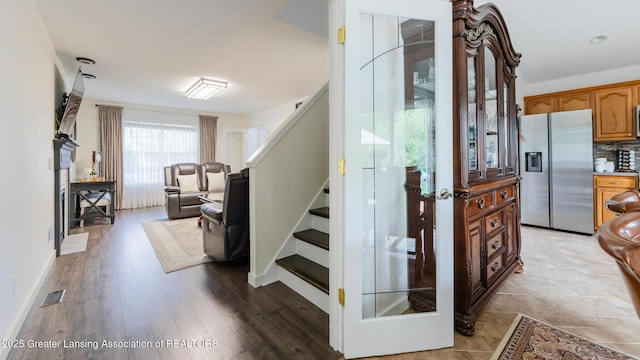 1100 Cranbrook Ln, Mason, MI 48854 - stairway featuring wood finished floors and baseboards